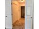 Hallway featuring tile flooring and white paneled doors, leading to a toilet at 1271 Whitlock Ridge Sw Dr, Marietta, GA 30064
