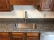 Close-up of a stainless steel sink with granite countertops and wood cabinetry at 1271 Whitlock Ridge Sw Dr, Marietta, GA 30064