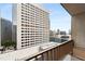 This balcony showcases a cityscape view with a table and chairs on concrete flooring at 145 15Th Ne St # 1430, Atlanta, GA 30309