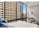 Bedroom featuring large windows offering city views, and a sitting chair at 145 15Th Ne St # 1430, Atlanta, GA 30309