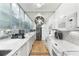 Bright kitchen featuring marble countertops, white appliances, and frosted glass cabinets at 145 15Th Ne St # 1430, Atlanta, GA 30309
