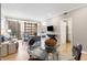 Open-concept living area featuring a dining table and a view of the city skyline at 145 15Th Ne St # 1430, Atlanta, GA 30309