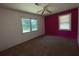 Bedroom boasts a bold accent wall complemented by dual windows, creating a bright space at 2369 Christian Cir, Covington, GA 30016