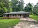 Ranch style house with brick, covered porch, and covered driveway at 2369 Christian Cir, Covington, GA 30016