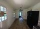 Cozy kitchen featuring a vintage chandelier, refrigerator, and original hardwood floors at 2369 Christian Cir, Covington, GA 30016