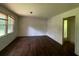 Bright living room featuring sleek, dark hardwood floors, complemented by a large window at 2369 Christian Cir, Covington, GA 30016