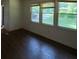 Inviting living room bathed in natural light from three windows, showcasing dark wood floors at 2369 Christian Cir, Covington, GA 30016