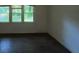 Inviting living room bathed in natural light from three windows, showcasing dark wood floors at 2369 Christian Cir, Covington, GA 30016