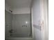 Tub and shower combination with grey tile at 2369 Christian Cir, Covington, GA 30016