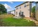 This home's backyard features a lawn, wooden fence, patio, and grill at 305 Hidden Creek Ln, Canton, GA 30114