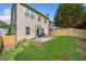 This home's backyard features a lawn, wooden fence, patio, and grill at 305 Hidden Creek Ln, Canton, GA 30114