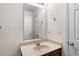Neutral bathroom with a single sink, large mirror, and white doors at 305 Hidden Creek Ln, Canton, GA 30114