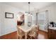 Bright dining room with hardwood floors, wainscoting, and a stylish light fixture at 305 Hidden Creek Ln, Canton, GA 30114