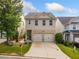 Inviting two-story home featuring a two-car garage, well-maintained lawn and cozy front porch at 305 Hidden Creek Ln, Canton, GA 30114