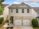 Charming two-story home with a two-car garage and landscaped front yard at 305 Hidden Creek Ln, Canton, GA 30114
