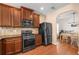 Modern kitchen features stainless steel appliances and dark wood cabinetry at 305 Hidden Creek Ln, Canton, GA 30114