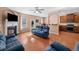 Cozy living room features a fireplace, hardwood floors, and comfortable blue sofas at 305 Hidden Creek Ln, Canton, GA 30114