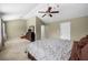 Spacious main bedroom with ceiling fan, neutral paint, carpet and a dresser with mirror at 305 Hidden Creek Ln, Canton, GA 30114