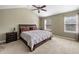 Spacious primary bedroom with a tray ceiling, carpeted floors, and plenty of natural light at 305 Hidden Creek Ln, Canton, GA 30114