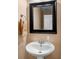 Clean and simple powder room with pedestal sink and modern mirror at 305 Hidden Creek Ln, Canton, GA 30114