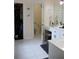 Bathroom with walk-in closet, tile floors, double vanity, and separate toilet area at 405 Mallory Cir, Loganville, GA 30052