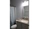 Cozy bathroom featuring a granite vanity top and a patterned shower curtain at 405 Mallory Cir, Loganville, GA 30052