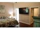 Bedroom with hardwood floors, mounted TV, and access to outdoors at 405 Mallory Cir, Loganville, GA 30052