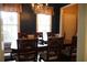 Elegant dining room with a chandelier, large windows, and seating for six, perfect for dinner parties at 405 Mallory Cir, Loganville, GA 30052