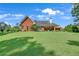 Exterior showcasing a brick home with a well-maintained lawn and charming architectural details at 405 Mallory Cir, Loganville, GA 30052