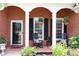 Inviting front porch with rocking chairs and hanging flower baskets, perfect for relaxing outdoors at 405 Mallory Cir, Loganville, GA 30052