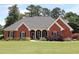 Charming brick home with well-maintained landscaping and inviting front lawn at 405 Mallory Cir, Loganville, GA 30052