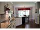 Open-concept kitchen featuring stainless appliances, granite countertops and a seamless connection to dining area at 405 Mallory Cir, Loganville, GA 30052