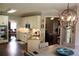 Bright kitchen with stainless steel appliances, tile backsplash, granite counters, and hardwood floors at 405 Mallory Cir, Loganville, GA 30052