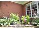 Lovely brick home with well-maintained landscaping and manicured garden with colorful flowers at 405 Mallory Cir, Loganville, GA 30052