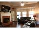 Bright living room with fireplace, built-in shelving, and large windows, ideal for entertaining at 405 Mallory Cir, Loganville, GA 30052