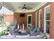Inviting outdoor patio with comfortable seating, a brick wall, and lush landscaping at 405 Mallory Cir, Loganville, GA 30052