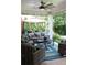 Covered outdoor patio with comfortable seating, a ceiling fan and stylish decor at 405 Mallory Cir, Loganville, GA 30052