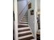 Stairway with hardwood steps and white risers, complemented by light gray walls at 405 Mallory Cir, Loganville, GA 30052