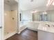 Bright bathroom featuring a shower, soaking tub, and double sink vanity with ample counter space and cabinet storage at 4133 Rosedown Nw Ct, Kennesaw, GA 30144