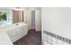 Bright bathroom with modern vanity, spacious countertops, and tile accents around the mirror and bath area at 4133 Rosedown Nw Ct, Kennesaw, GA 30144