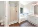This primary bathroom features a soaking tub, standup shower, and double sink vanity, complete with wood-look floors at 4133 Rosedown Nw Ct, Kennesaw, GA 30144