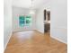 Bright dining area with laminate floors, a modern chandelier, and a view of the lush backyard at 4133 Rosedown Nw Ct, Kennesaw, GA 30144