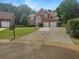 Beautiful two-story brick home with blue shutters, a manicured lawn and a long driveway at 4133 Rosedown Nw Ct, Kennesaw, GA 30144