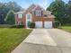 Traditional two-story brick home with a well-manicured lawn and a two-car garage at 4133 Rosedown Nw Ct, Kennesaw, GA 30144