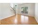 Inviting living room with wood floors, lots of natural light, and staircase access to upper level at 4133 Rosedown Nw Ct, Kennesaw, GA 30144