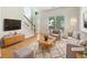 Bright, staged living room with hardwood floors and a cozy seating area at 4133 Rosedown Nw Ct, Kennesaw, GA 30144