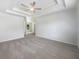 Spacious main bedroom with modern ceiling fan and tray ceiling, filled with natural light at 4133 Rosedown Nw Ct, Kennesaw, GA 30144