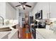 Bright kitchen with white cabinets, stainless steel appliances, white subway tile, and hardwood floors at 5832 Sloane St, Douglasville, GA 30135