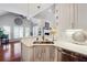 Open kitchen layout featuring white cabinets, stainless steel appliances, and a view into the living room at 5832 Sloane St, Douglasville, GA 30135