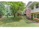 A well-manicured backyard featuring a swing, deck, and lush greenery around the home at 2291 Smokehouse Path, Lawrenceville, GA 30044